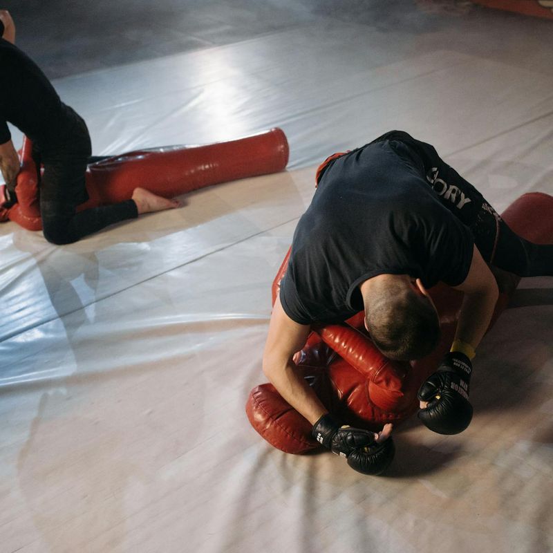 A man in athletic wear performing a push-up with perfect form.