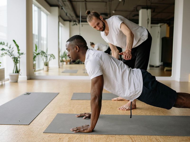 Man focused on a difficult balance exercise, showing concentration.